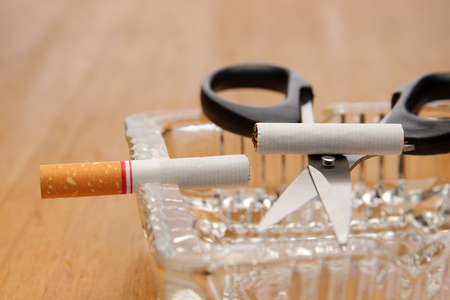 scissors cut a cigarette on ashtray, stop smoking conceptの写真素材