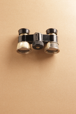old binoculars on brown paper background with spaceの写真素材