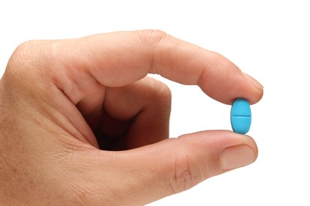 medicine in finger of man hand isolated on white backgroundの写真素材