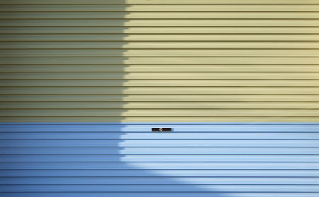 pastel color door in light and shadow, background photo with space for text or imageの写真素材