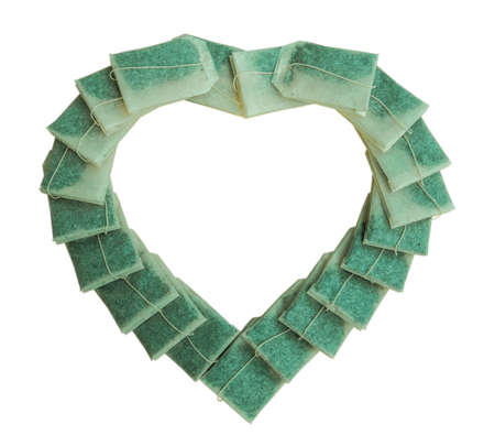 Healthy instant tea bags Several tea bags are arranged in a heart shape on a white background.の写真素材
