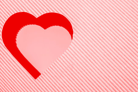 Pink and red heart-shaped corrugated paper on the mirror reflectionの写真素材