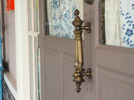 Metal door handle on wooden doorの写真素材