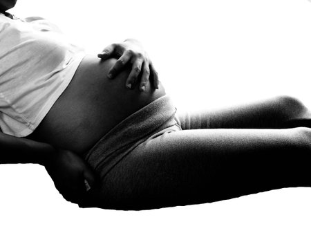Pregnant woman having back aches in the last trimester of pregnancy