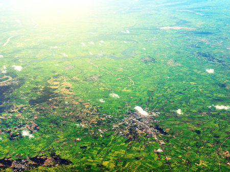 Aerial view of clouds and village landscape. View from aircraft window.の写真素材