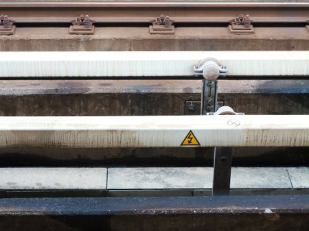 High voltage electrified rail along railroad train tracks