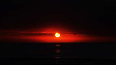 red sunset on the black skyの写真素材