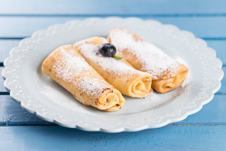 Three homemade rolled pancakes with blueberryの写真素材