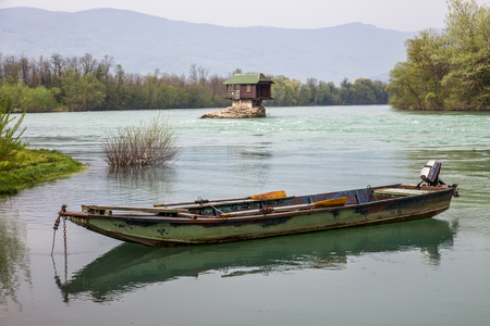 Lonely house and small boat on the river Drina, Serbiaの写真素材
