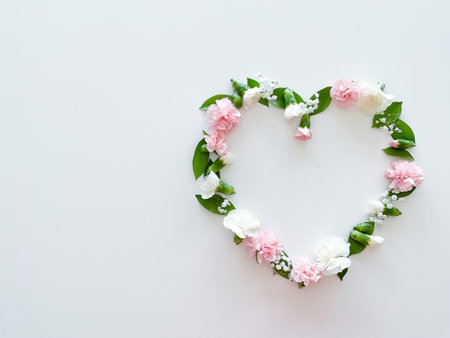 Frame in form of heart from pink, white carnationsの写真素材