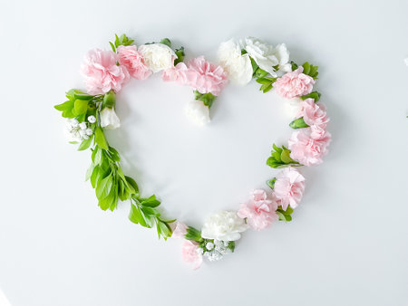 Frame in form of heart from pink, white carnationsの写真素材