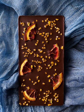 Dark chocolate with dried oranges and peanut crumbs, top view