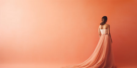 Ai generation. Young woman in long dress on peach background. Back view. Fashionの素材