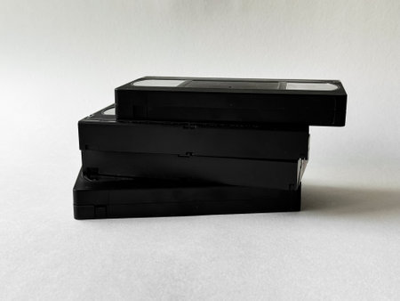 Retro nostalgia: stack of vintage vhs tapes against neutral backgroundの写真素材