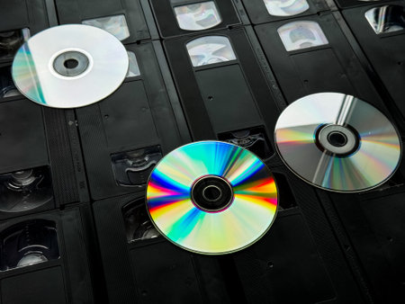 Retro media collection: vhs tapes and compact discs on displayの写真素材