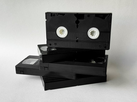 Stack of vintage vhs tapes on a white background highlighting retro media
