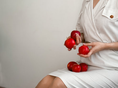 Minimalist lifestyle with fresh red apples and white dressの写真素材