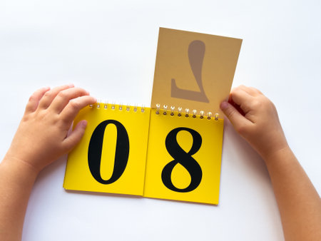 Child flipping calendar pages displaying numbers on yellow cards