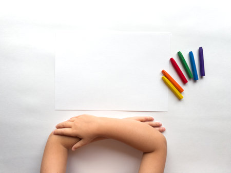 Childs creativity. Blank canvas with colorful crayons on white backgroundの写真素材