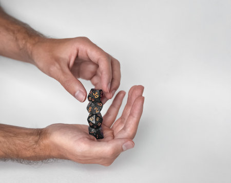 Hands holding mystery dice set gaming and fantasy role playing
