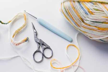 Colorful yarn with crochet hook and scissors for crafting projectsの写真素材