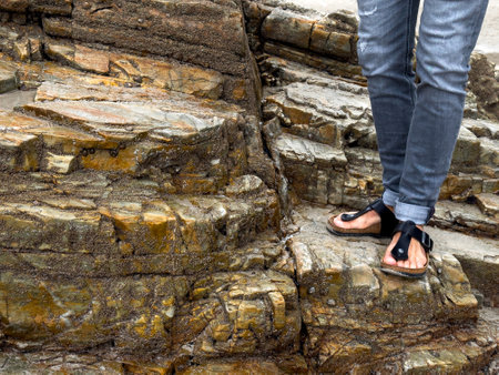 Casual footwear on rocky terrain by the beachの写真素材
