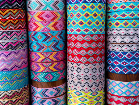 Colorful patterned textile rolls with traditional geometric designsの写真素材
