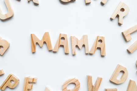 Wooden alphabet letters forming MAMA on white backgroundの写真素材