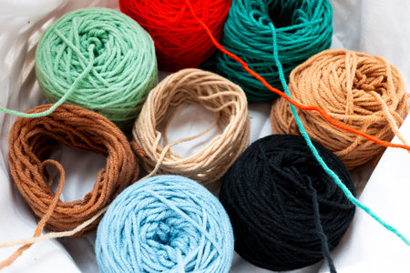 Colorful yarn balls in various textures and bright hues arranged in a basket