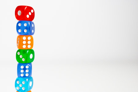 Colorful dice tower against white background