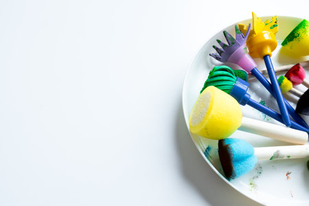 Colorful assortment of foam paint brushes on white backgroundの写真素材