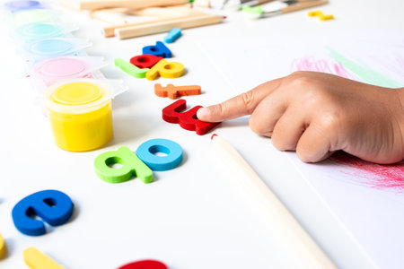 Child hands learning with colorful alphabet and numbers in creative activityの写真素材