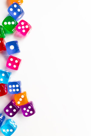 Colorful assorted dice on white background with copy spaceの写真素材