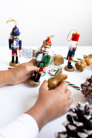 Child arranging nutcracker figurines for Christmas decorationsの写真素材