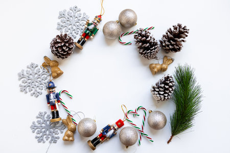 Festive Christmas wreath with nutcrackers, pine cones, and golden ornamentsの写真素材