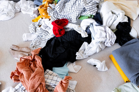 Pile of colorful laundry on beige sofa