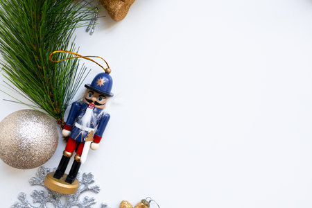 Festive nutcracker and pine branch on white background for holiday decor