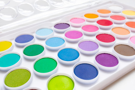 Colorful watercolor palette with assorted vibrant paintsの写真素材