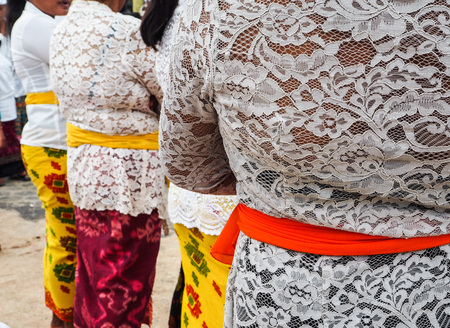 Group of Balinese women dressed in traditional clothing waiting in line for the Balinese New year procession, Nusa Lembongan, Indonesiaの写真素材