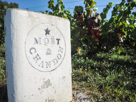 Champagne - Ardenne, France - AUgust 2017: Champagne house MoÃ«t & Chandon old stone roadside sign next to the vineyards in Hautvillers close to Epernayのeditorial素材