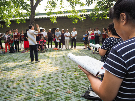 Beijing, China - September 2017: group of middle aged and retired people singing together in the park of the Temple of Heaven on a Sunday afternoonのeditorial素材