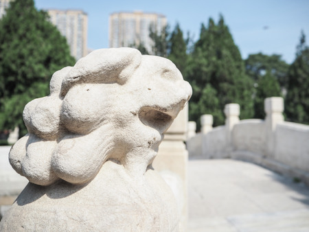 White stone lion on a bridge guarding the entrance to the Confucius temple in Tianjin, Chinaの写真素材