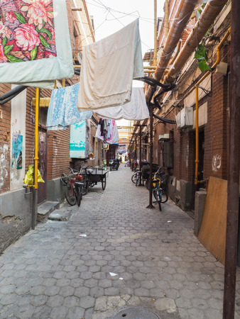 Traditional neighborhood with old houses and laundry hanging outside in the French concession in the city center of Tianjin, Chinaのeditorial素材
