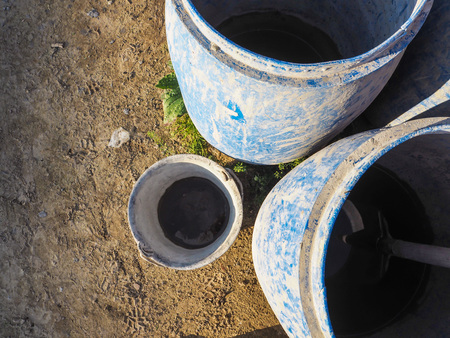 Top view of blue plastic barrels and metal bucket used on a construction siteの写真素材