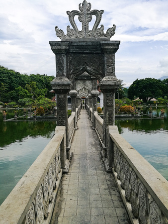 Stone bridge with archways leading up to the main building Gili Bale at Taman Ujung Water Palace, Bali, Indonesiaのeditorial素材