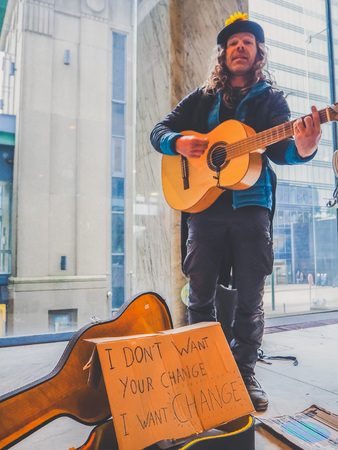 January 2019 - Brussels, Belgium: male street artist playing guitar during a climate change protest rally as a call to actionのeditorial素材