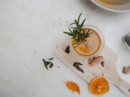 Glass with citrus, ginger  and rosemary flavored kombucha tea on a white backgroundの写真素材