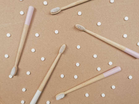 Bamboo toothbrush and dental tabs on a wooden background as a plastic free swap. Zero waste personal care products.の写真素材