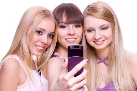 three girls with phone on a white backgroundの写真素材