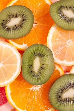 assorted fruits of apple, grapefruit, orange, lemon and kiwi as a backgroundの写真素材